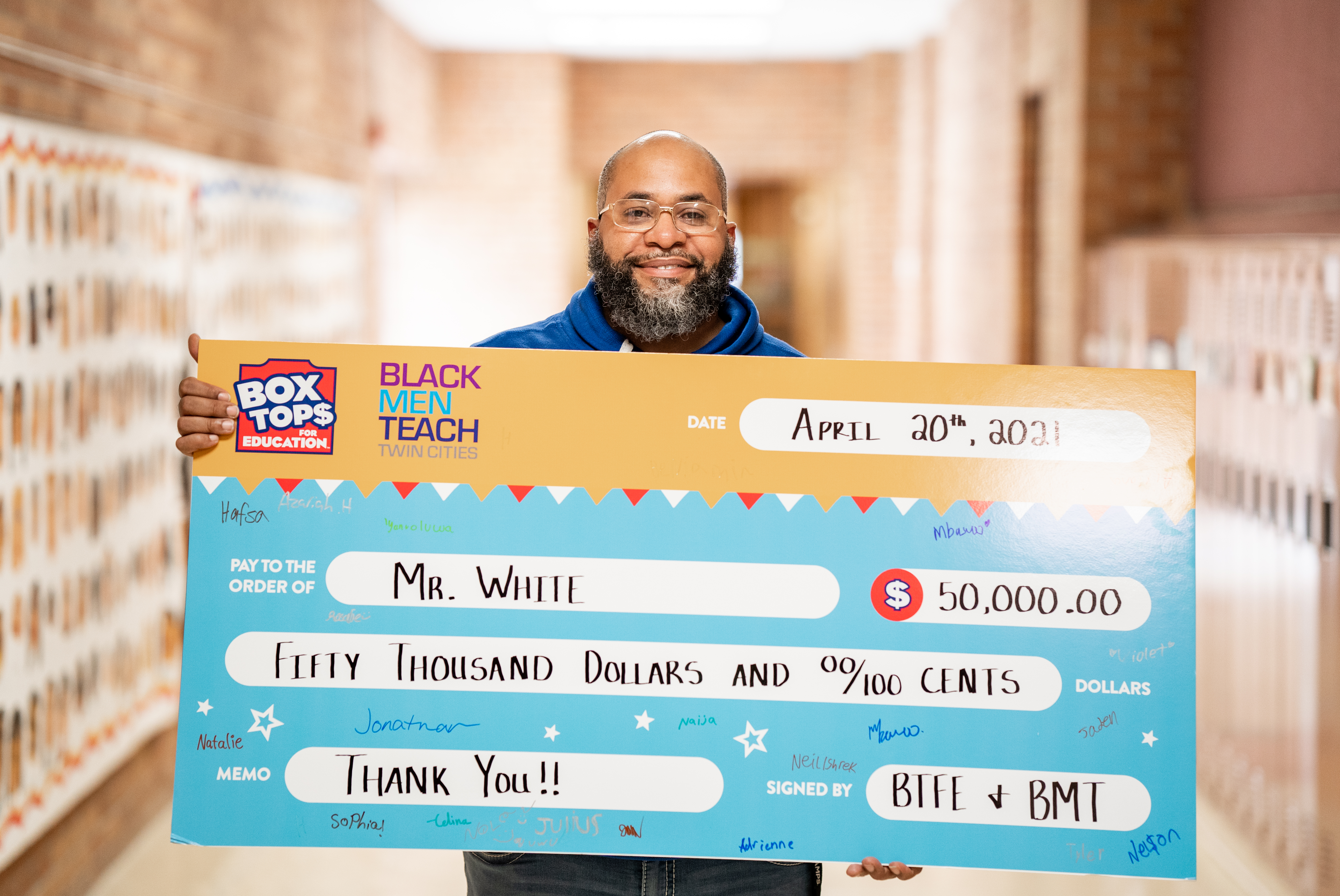 Mr. White holding Box Tops check